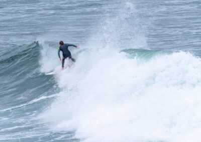 Surfer riding a ocean wave on the Victorian coast featured in The Long Road Home